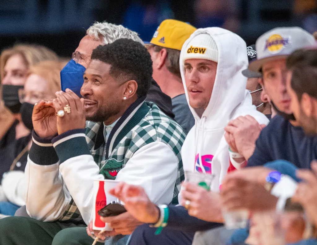 Usher and Justin Bieber watching a Golden State Warriors vs. Los Angeles Lakers game.