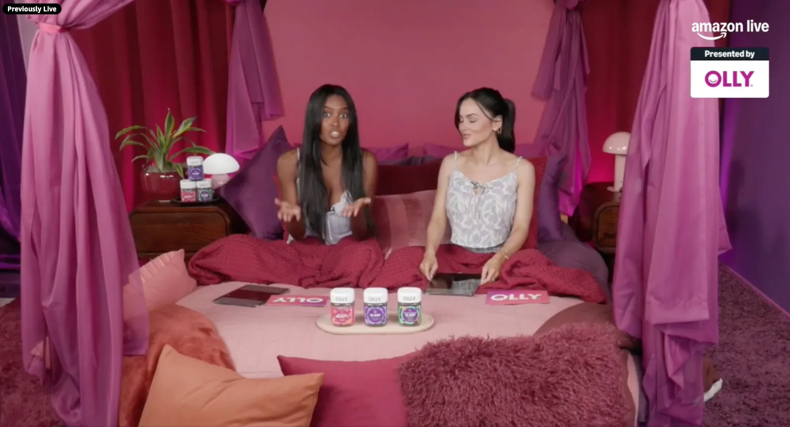 Two women promoting OLLY products in a bedroom setting.