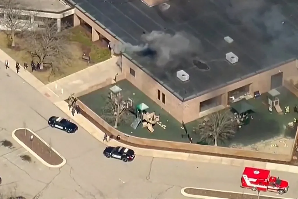 Aerial view of smoke rising from the Temple Israel Synagogue after an active shooting incident.