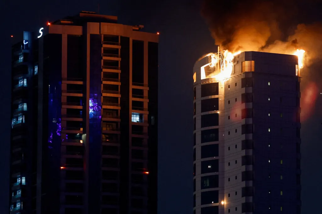 Smoke rising from a burning building hit by an Iranian drone strike in Manama.