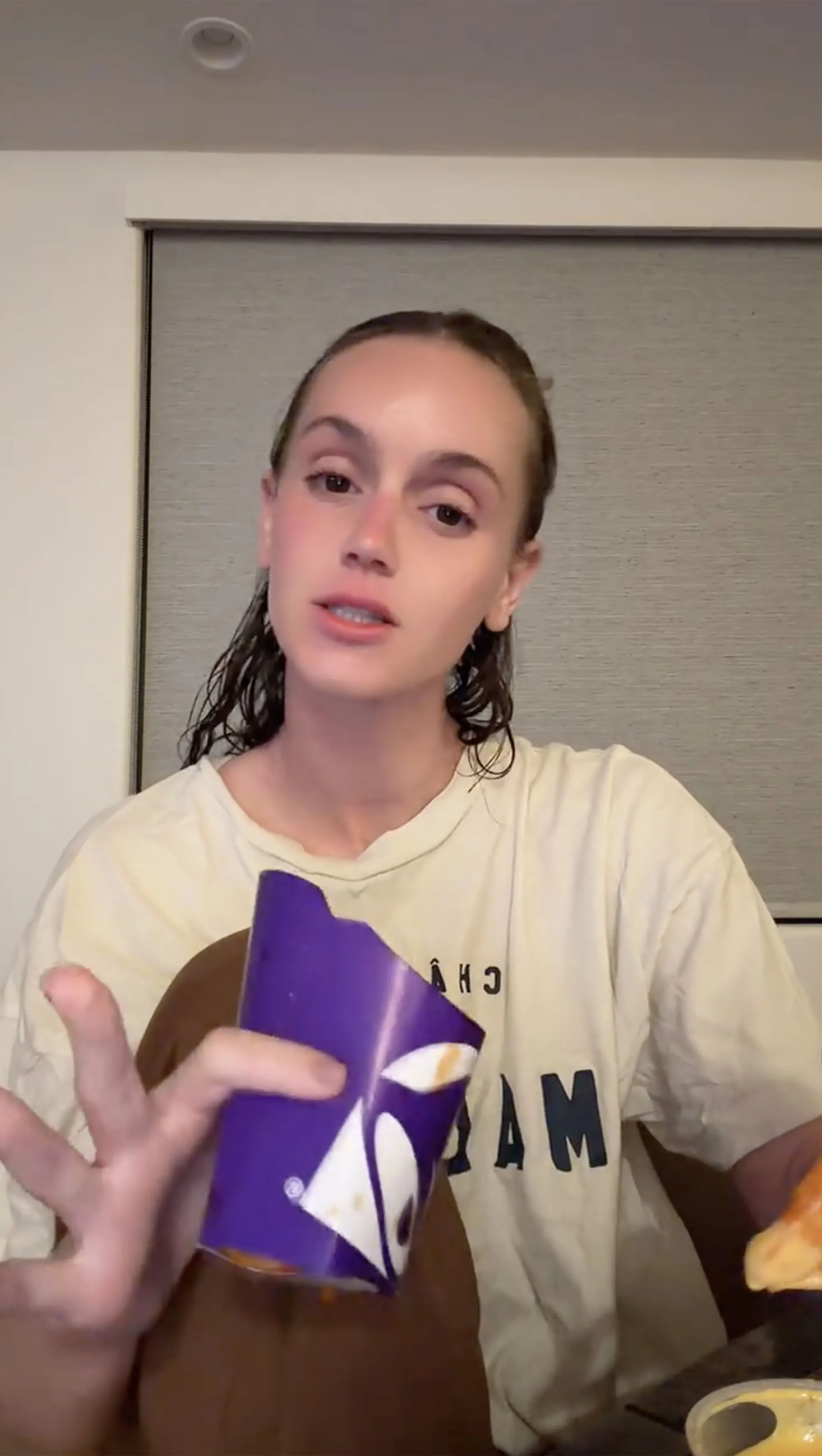 Mikayla Matthews holding a purple Taco Bell cup.