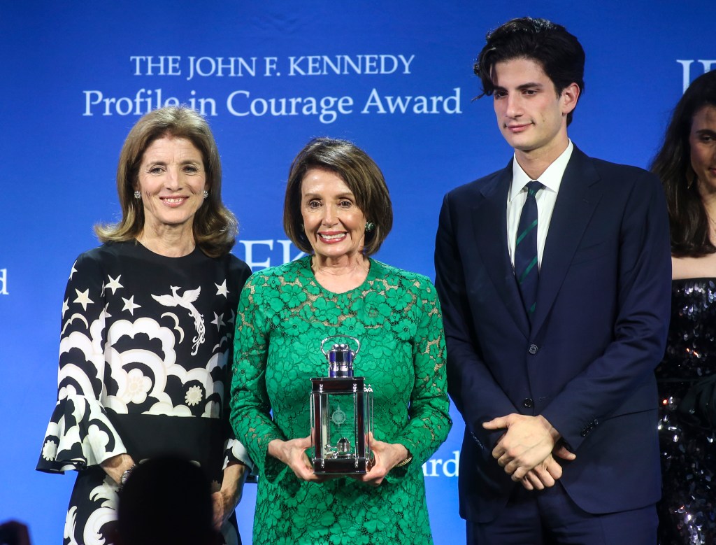 Nancy Pelosi accepting the Profile in Courage Award, flanked by Caroline Kennedy and Jack Schlossberg.