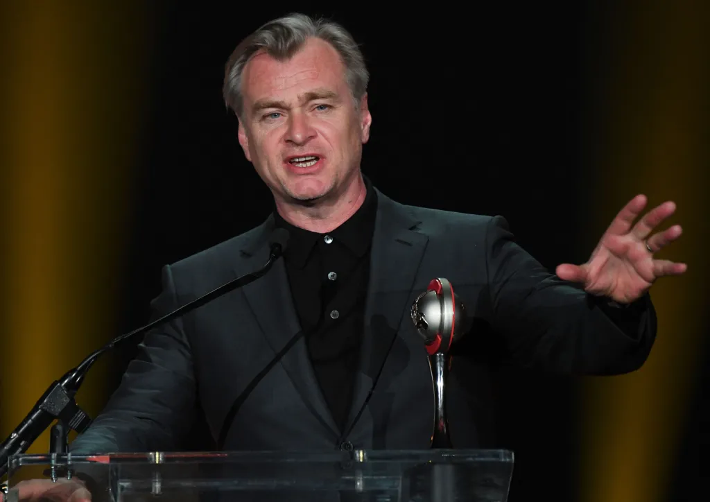 British director Christopher Nolan speaks on stage next to his NATO Spirit of the Industry Award.