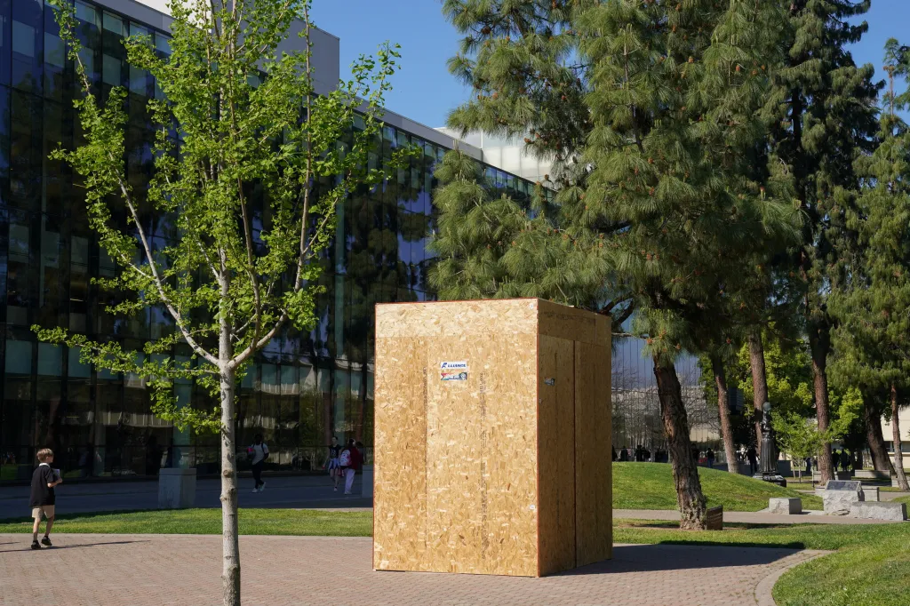 A statue of Cesar Chavez covered in a wooden box at Fresno State University.
