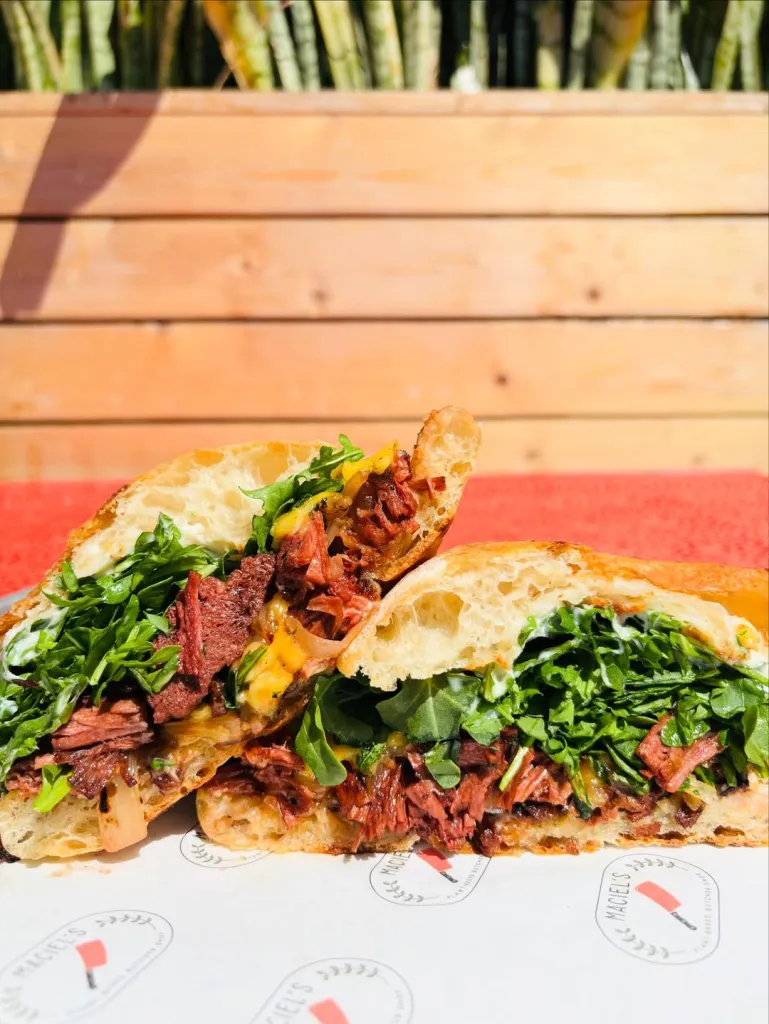 The Steak & Gouda sandwich from Maciel’s Plant-Based Butcher & Deli, with steak, caramelized onions, melted gouda, arugula, and horseradish aioli on toasted ciabatta.