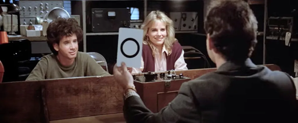 Bill Murray tests Jennifer Runyon and Steven Tash with a Zener card in a scene from Ghostbusters (1984).