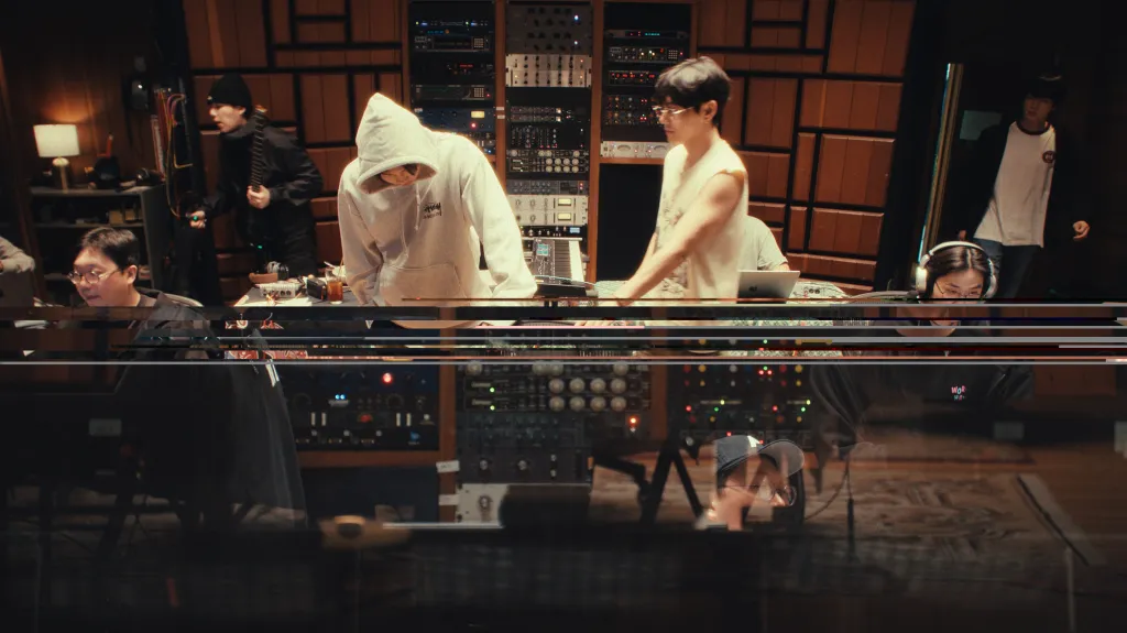 Suga, RM, V, and Jin from BTS in a recording studio.