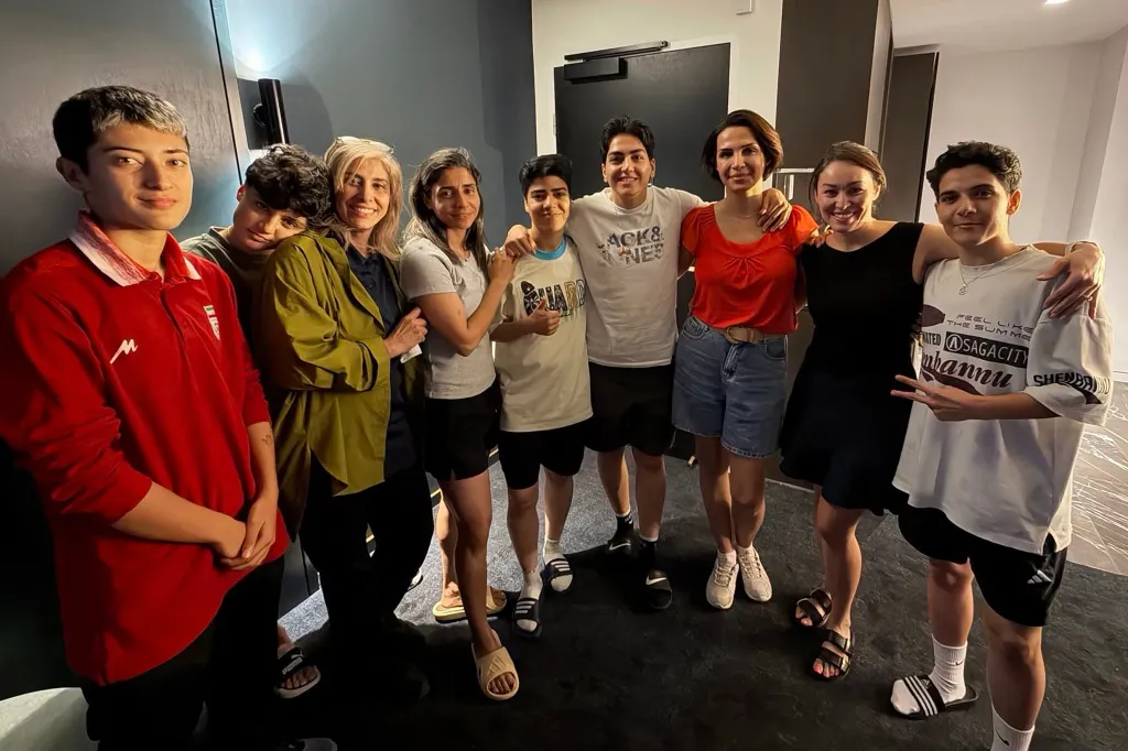 Six Iranian football players and a team official with two local officials pose together after claiming asylum in Australia.