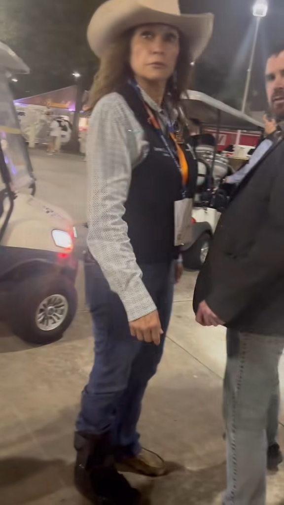 Lina Hidalgo in a cowboy hat and western wear with a man beside her.