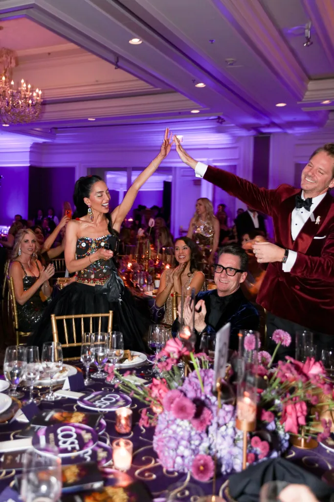 Thomas Pierce high-fiving Priya Jain at the 4th Annual Aspen Snow Ball.