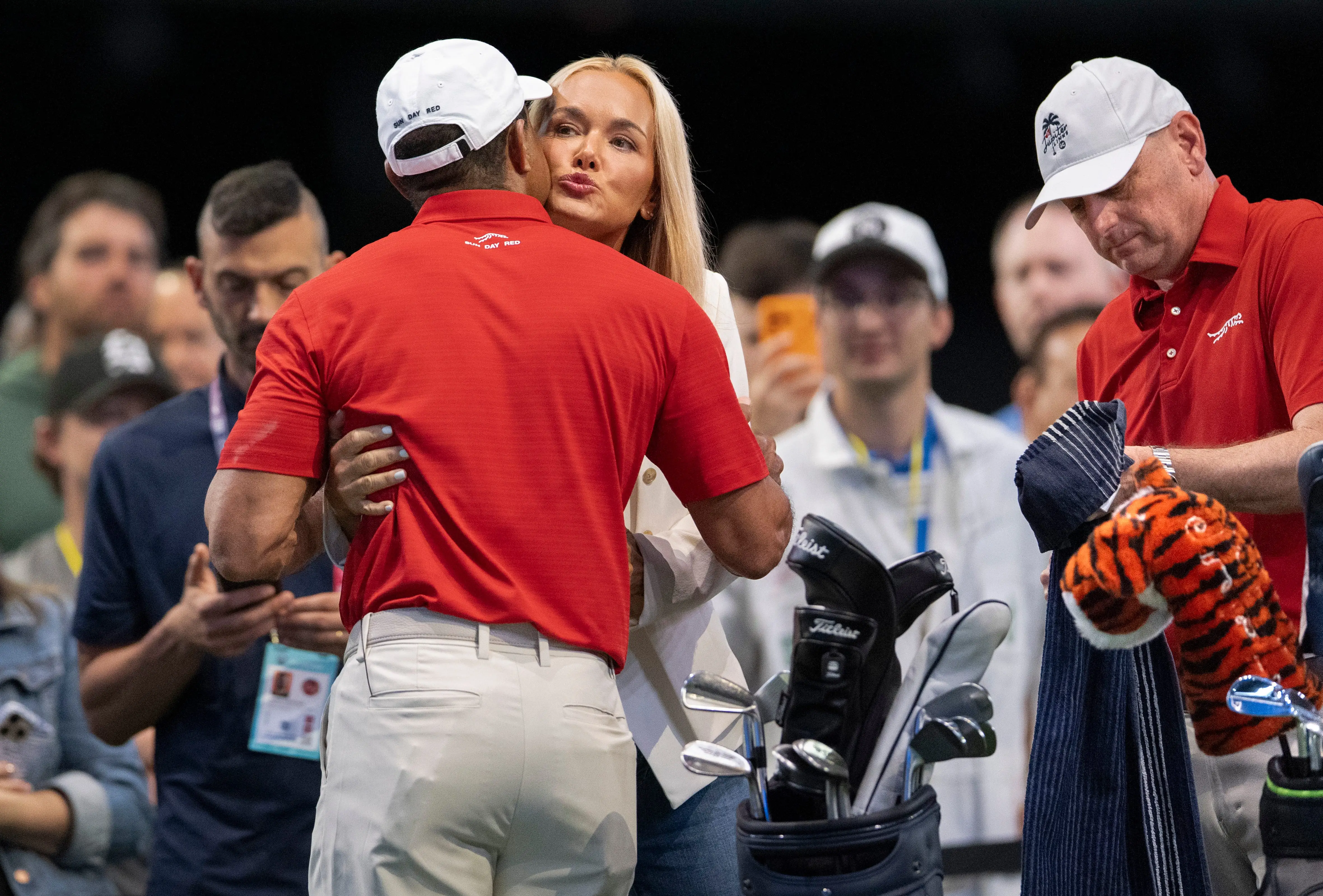 Vanessa Trump hugs and kisses Tiger Woods.
