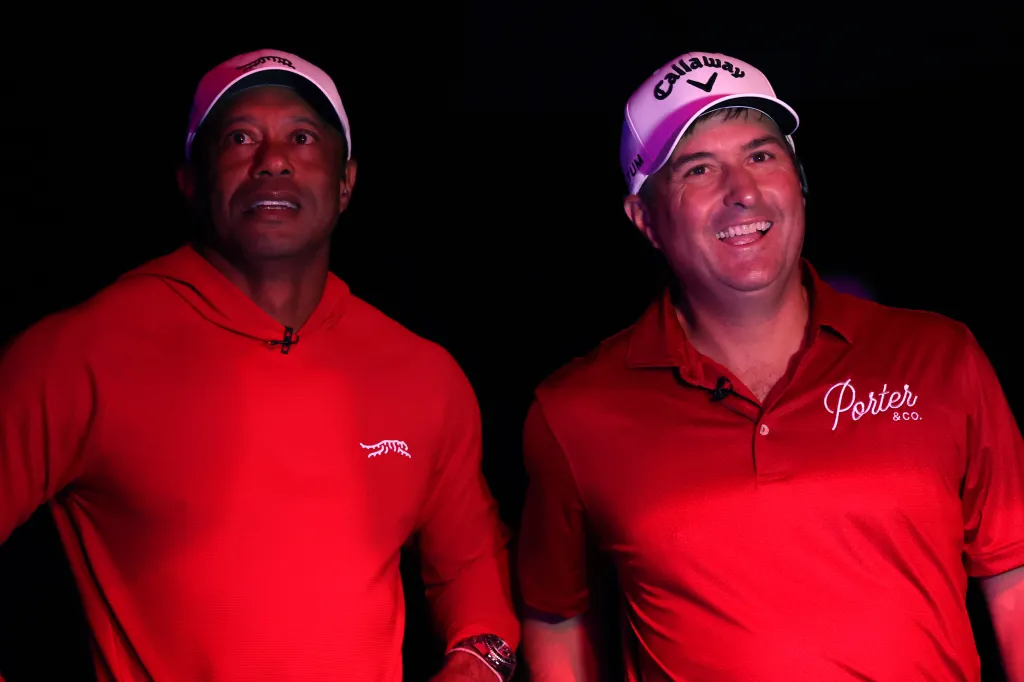 Tiger Woods and Kevin Kisner looking on during player introductions.