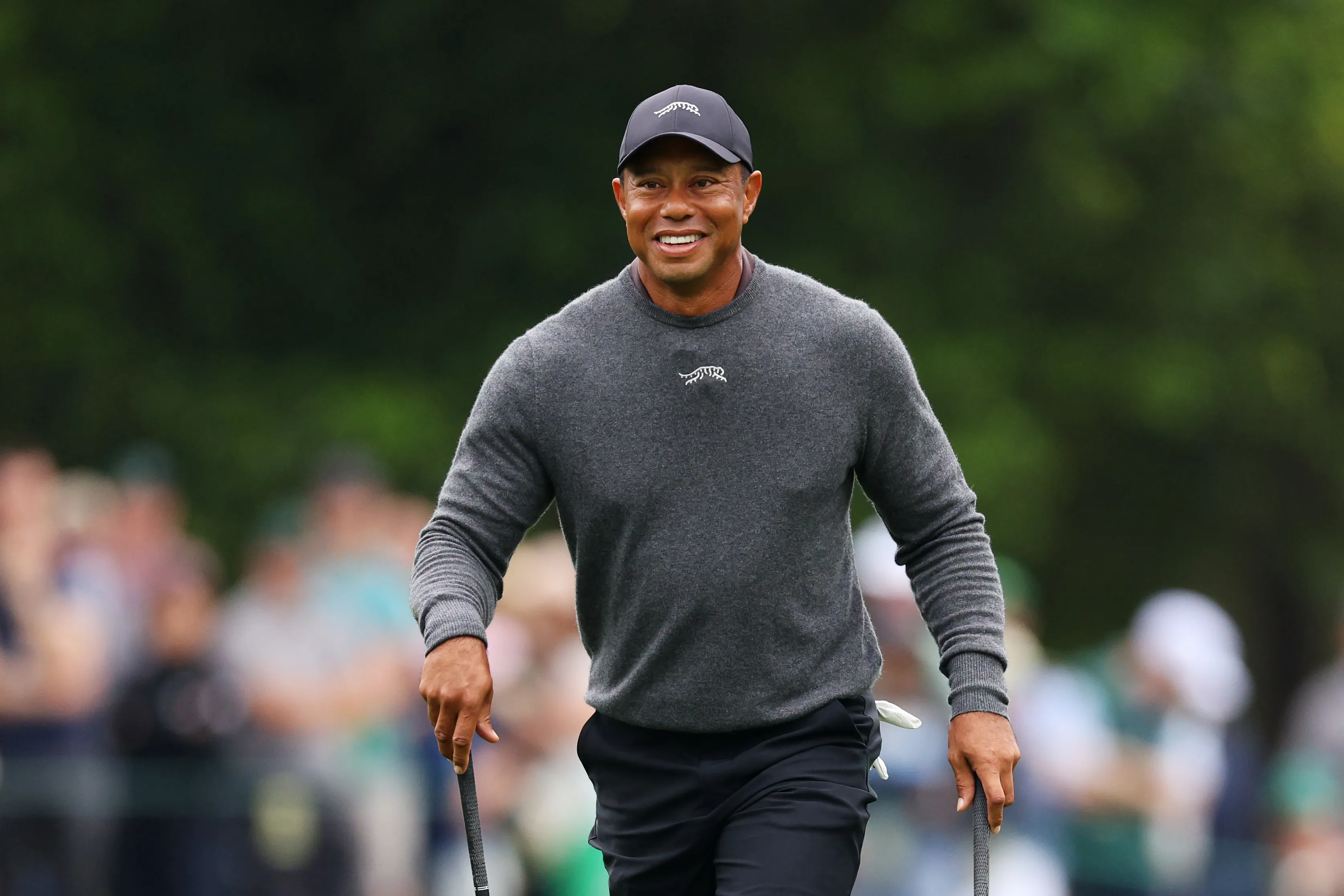 Tiger Woods smiling during a practice round at the Masters Tournament.