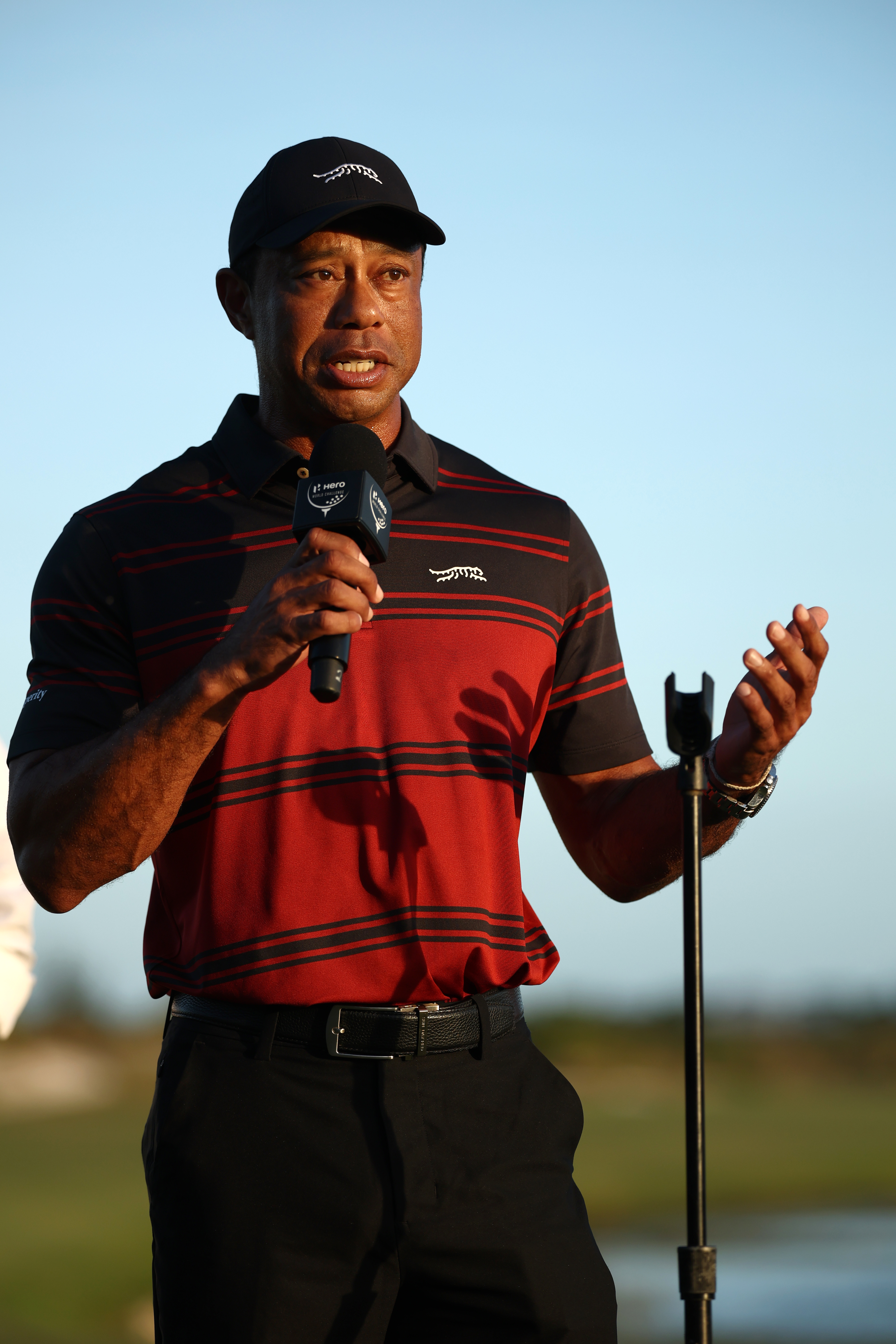 Tiger Woods speaking into a microphone.