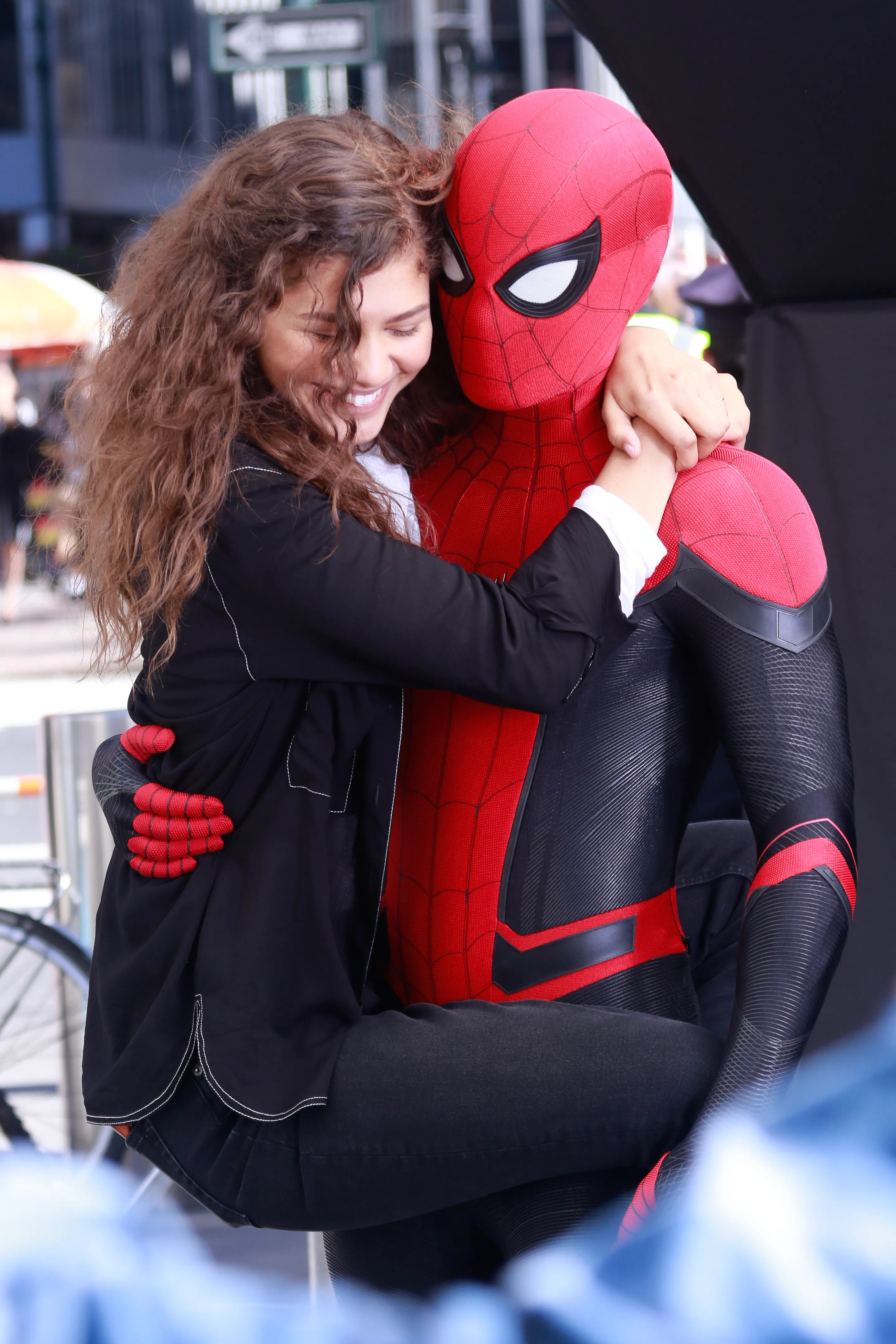 Tom Holland as Spider-Man embraces Zendaya.