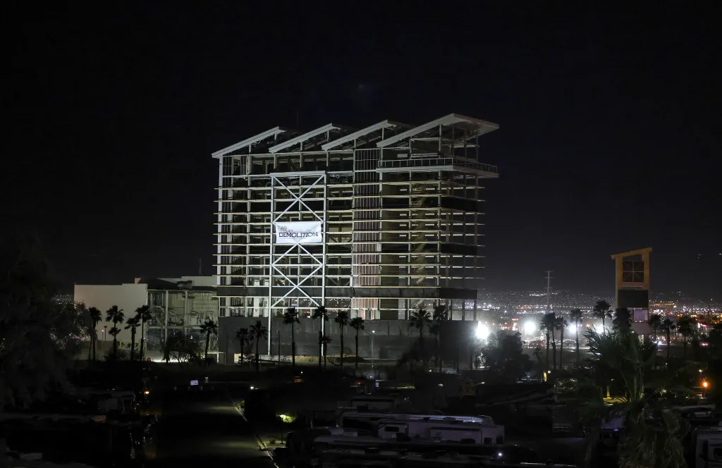 The tower of the Eastside Cannery Casino and Hotel lit up at night before its demolition.