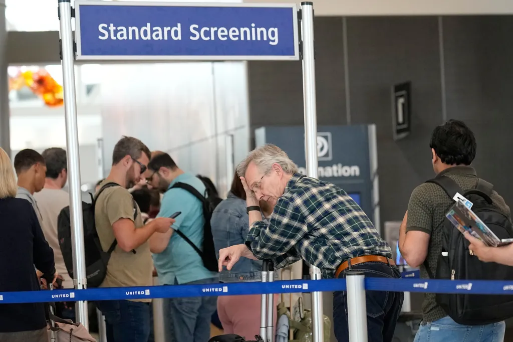 Travelers waiting in long security checkpoint lines at George Bush Intercontinental Airport.