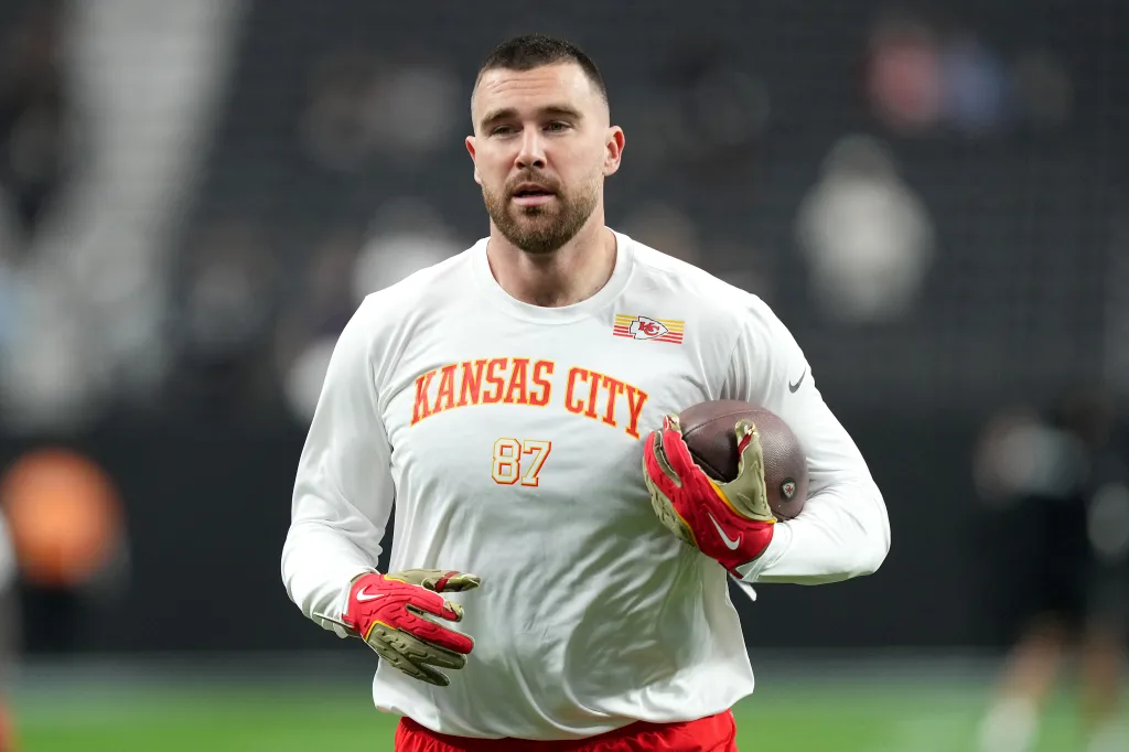 Travis Kelce #87 of the Kansas City Chiefs warms up, holding a football.