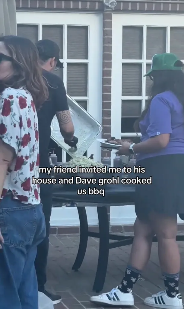 A person with a tattoo on their arm serving coleslaw from a large tray onto a barbecue grill, with text overlay