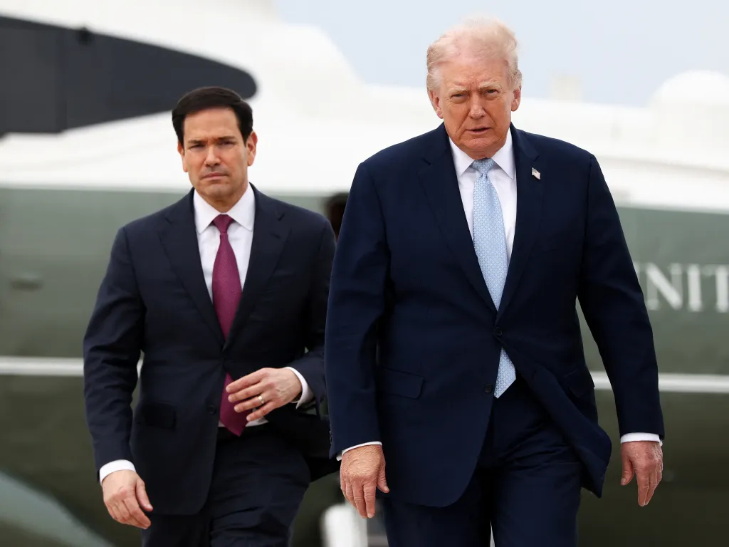 U.S. President Donald Trump and Secretary of State Marco Rubio walk towards Air Force One.