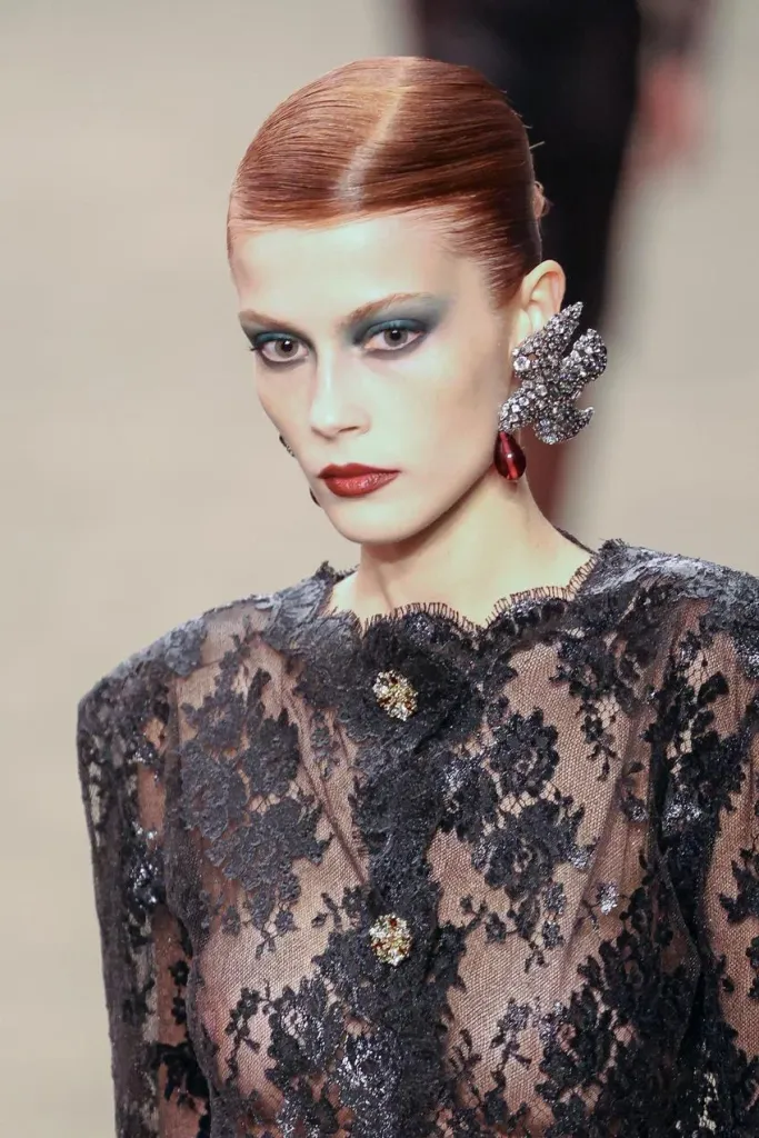 Smoldering smokey eye and modern lip noir looks created by Pat McGrath Labs on a model at the Saint Laurent Fall 2026 runway show. Source: Getty