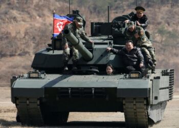 Teen daughter of North Korean leader Kim drives a tank while observing drill with her father
