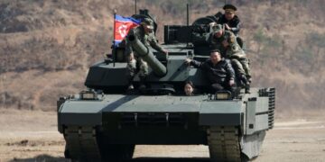 Teen daughter of North Korean leader Kim drives a tank while observing drill with her father