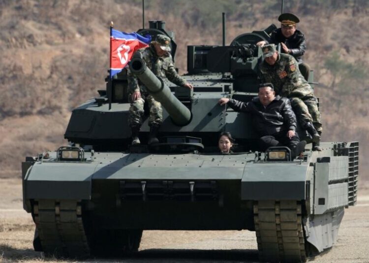 Teen daughter of North Korean leader Kim drives a tank while observing drill with her father
