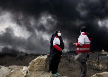 After attacks on Iran’s oil facilities, toxic black rain endangers the public