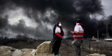 After attacks on Iran’s oil facilities, toxic black rain endangers the public
