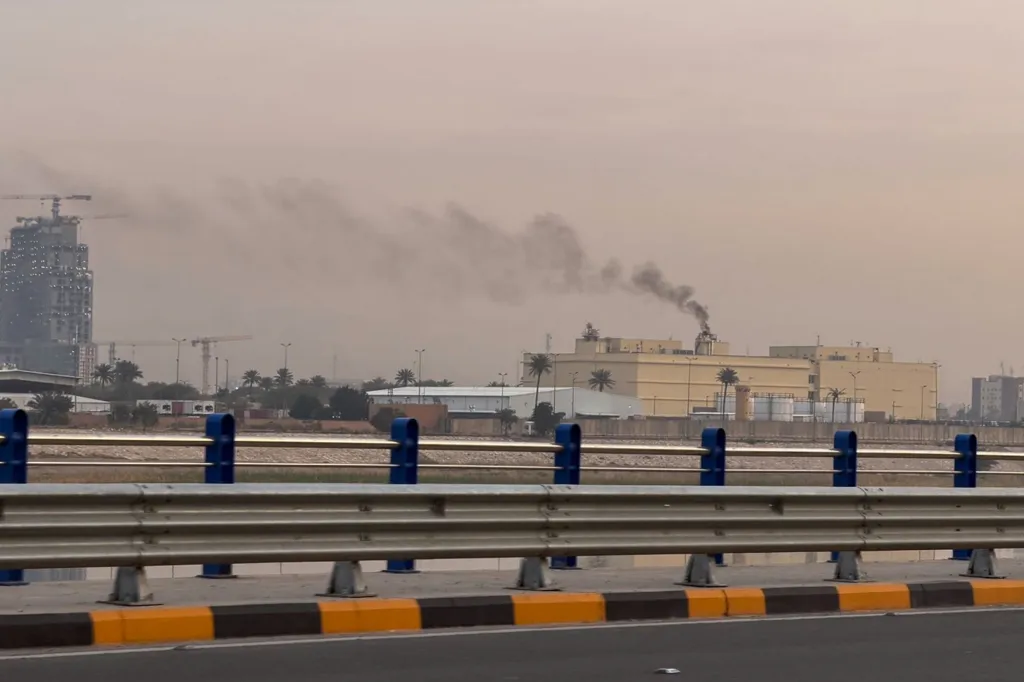 Smoke rises from industrial buildings at the US Embassy in Baghdad.