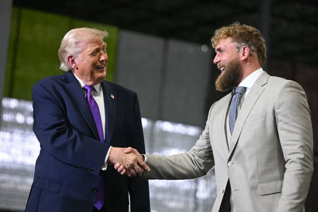 US President Donald Trump shakes hands with US boxer and influencer Jake Paul.