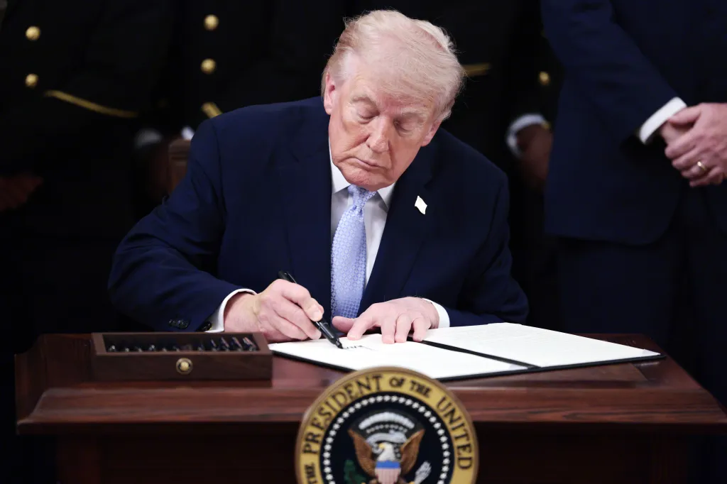US President Donald Trump signs an executive order at the White House.