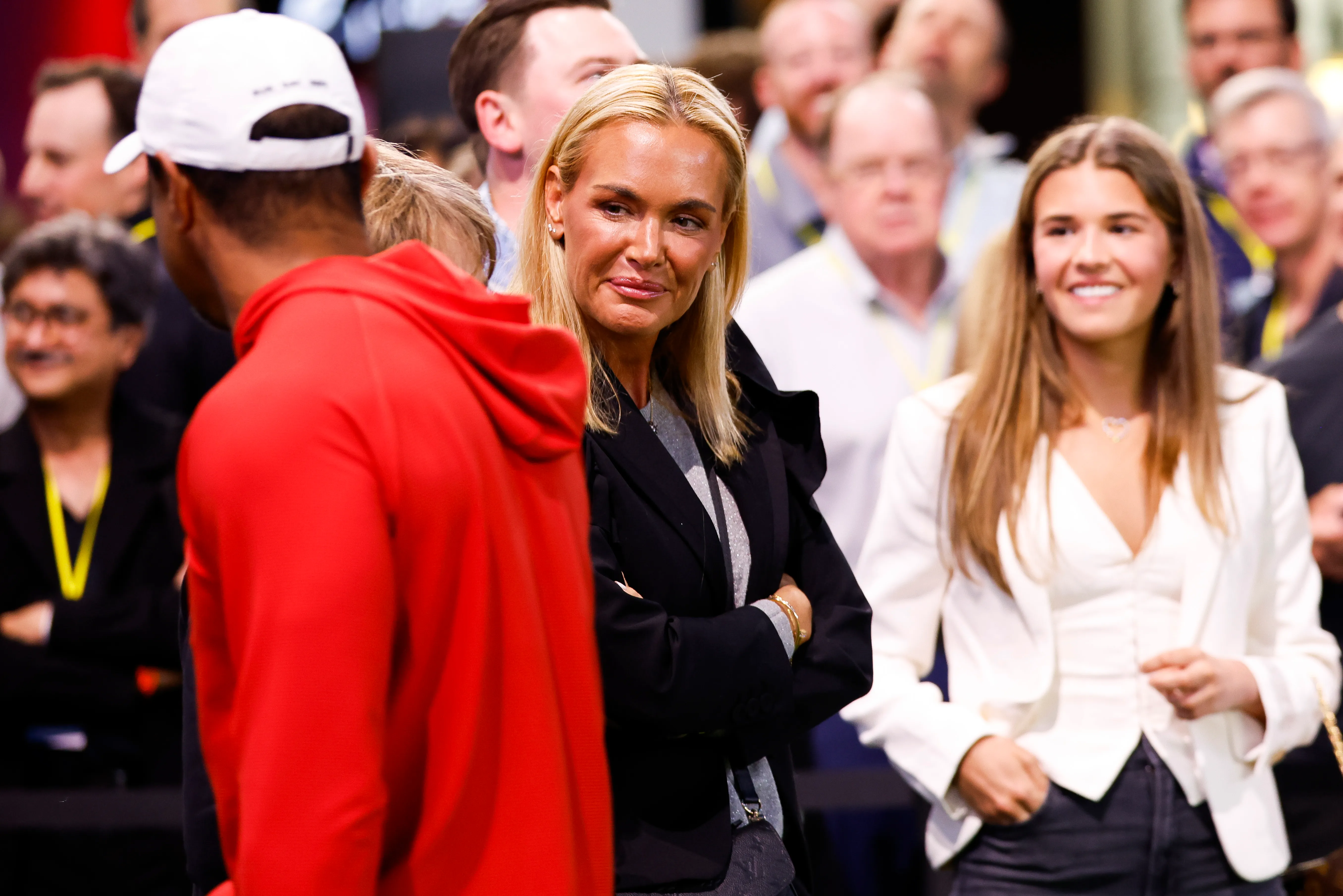 Vanessa Trump and her daughter Kai Trump speak with Tiger Woods.
