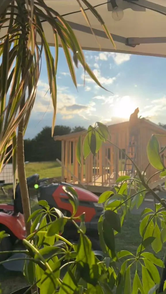 Tyler Neidhardt building a tiny house in a rural area.
