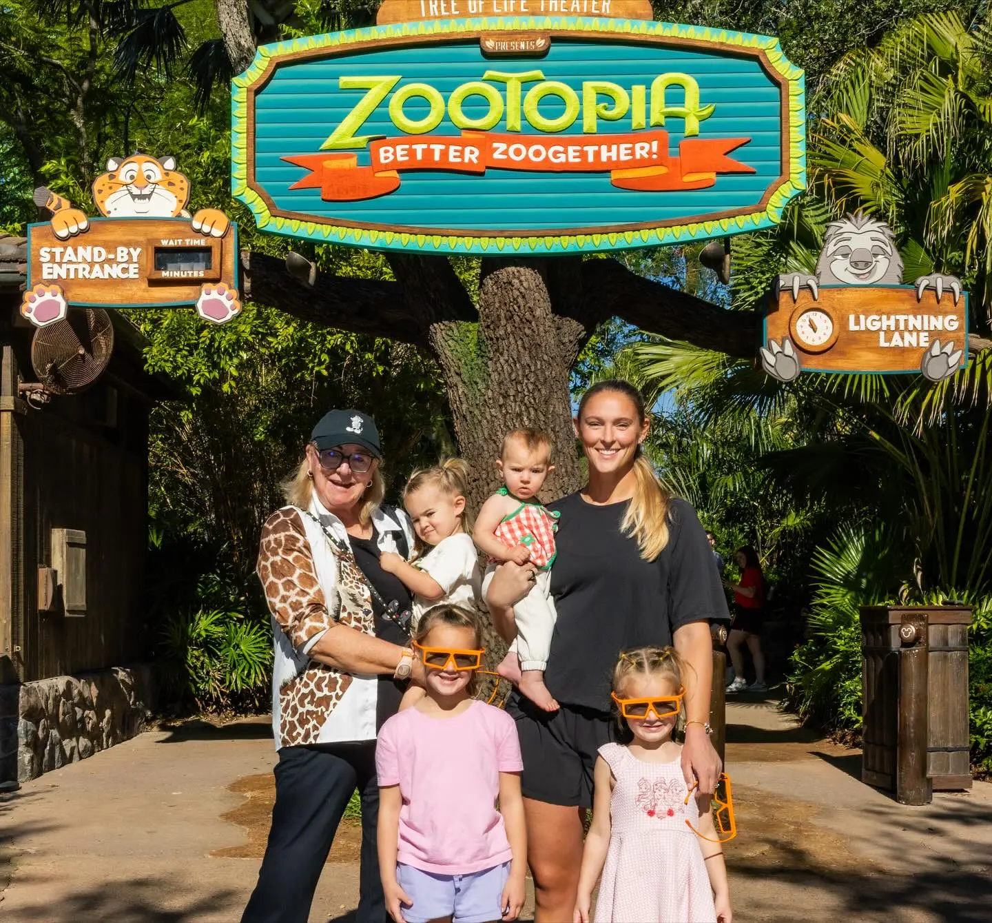 Kylie and Donna Kelce with their children and grandchildren under a 