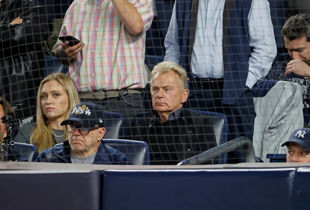 Pat Sajak sitting behind home plate at a World Series game.