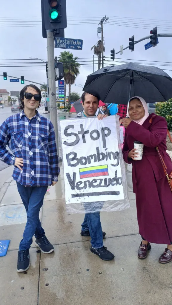 Three people holding a 