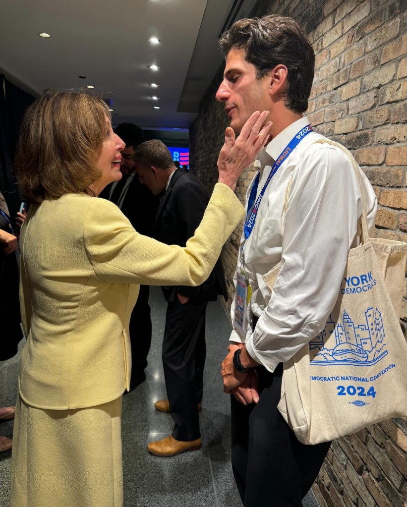 Nancy Pelosi touches a man's face at the 2024 Democratic National Convention.