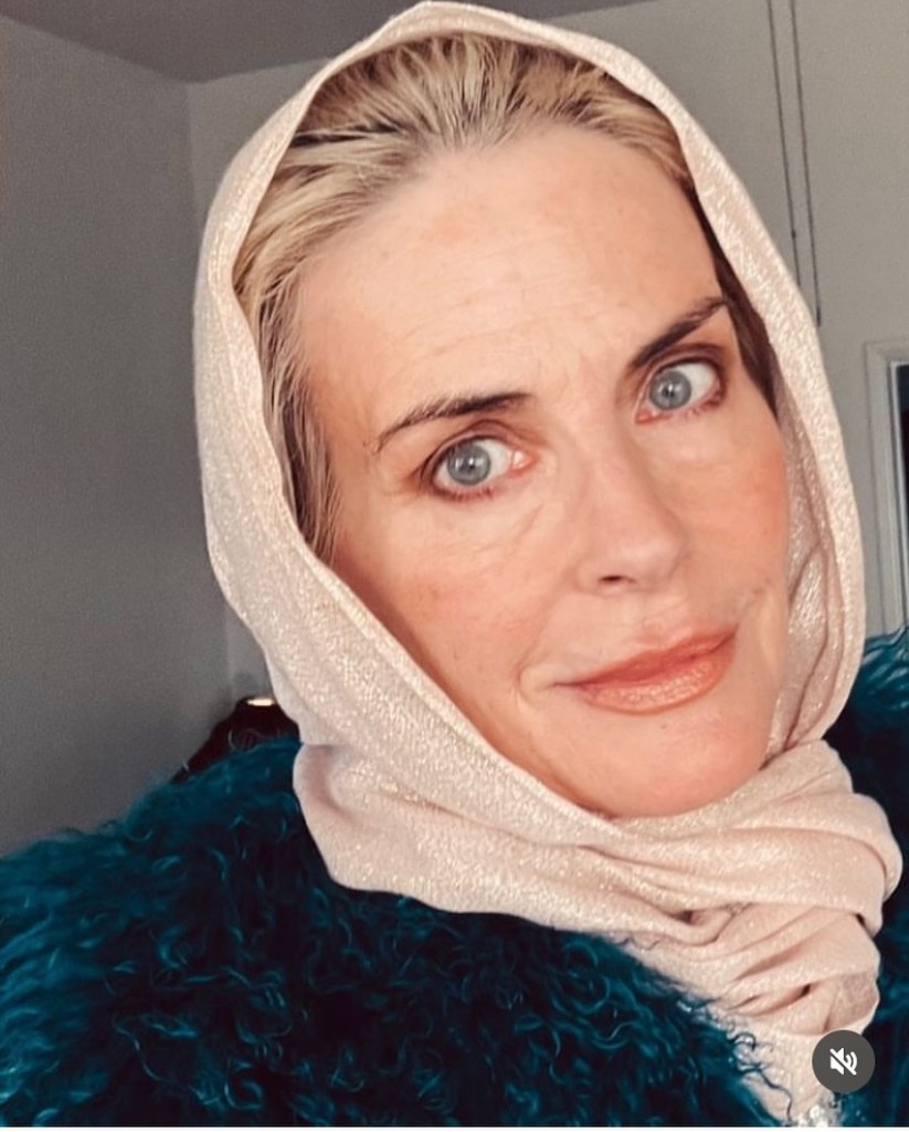 Annabel Schofield wearing a light headscarf and a teal, furry jacket.