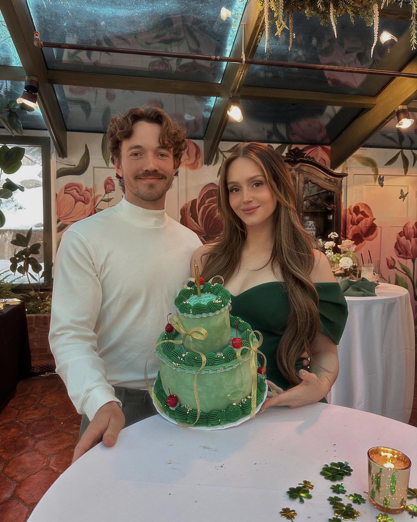 Mikaya Matthews and Terry posing with a green cake.