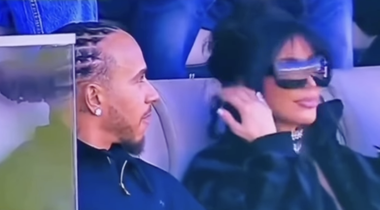Kim Kardashian and Lewis Hamilton sitting together at the Super Bowl.