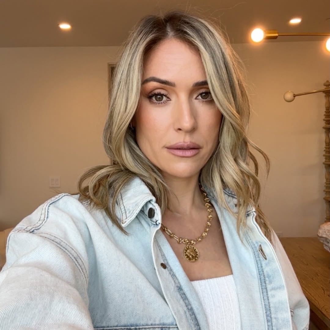 Kristin Cavallari wearing a light blue denim jacket, a white top, and a gold necklace.