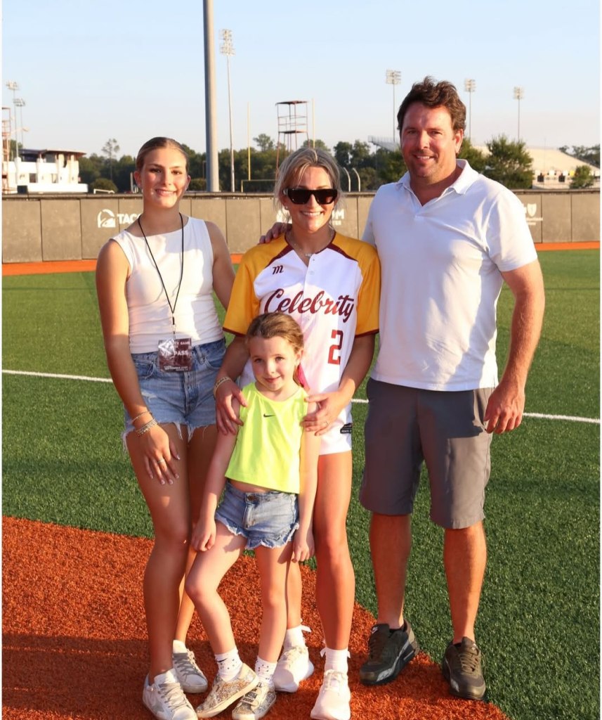 Jamie Lynn Spears poses with her family on a baseball field.