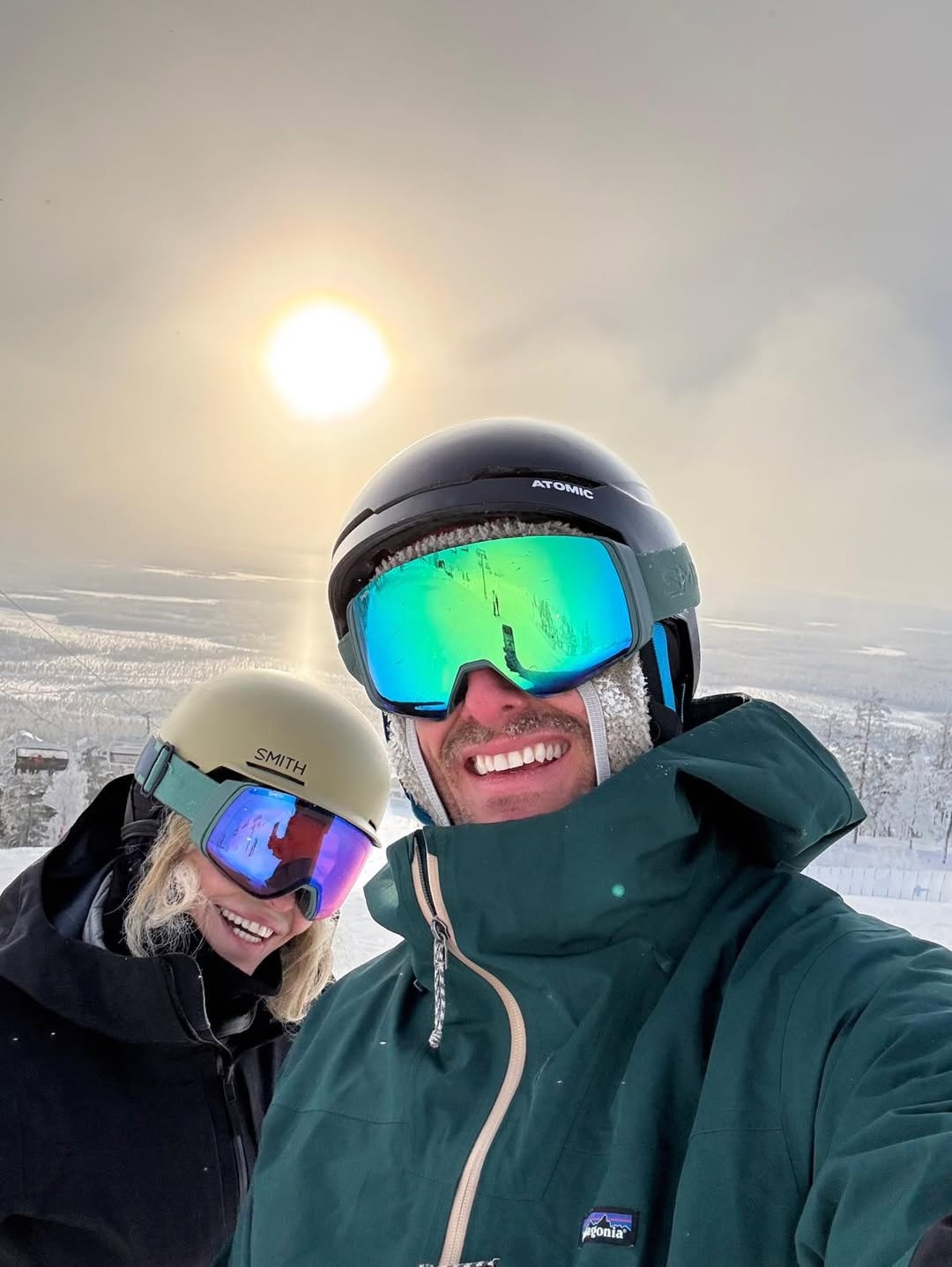 Chelsea Handler and her partner smile for a selfie while skiing.