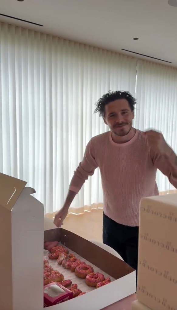 Brooklyn Beckham with a box of donuts that spell out 