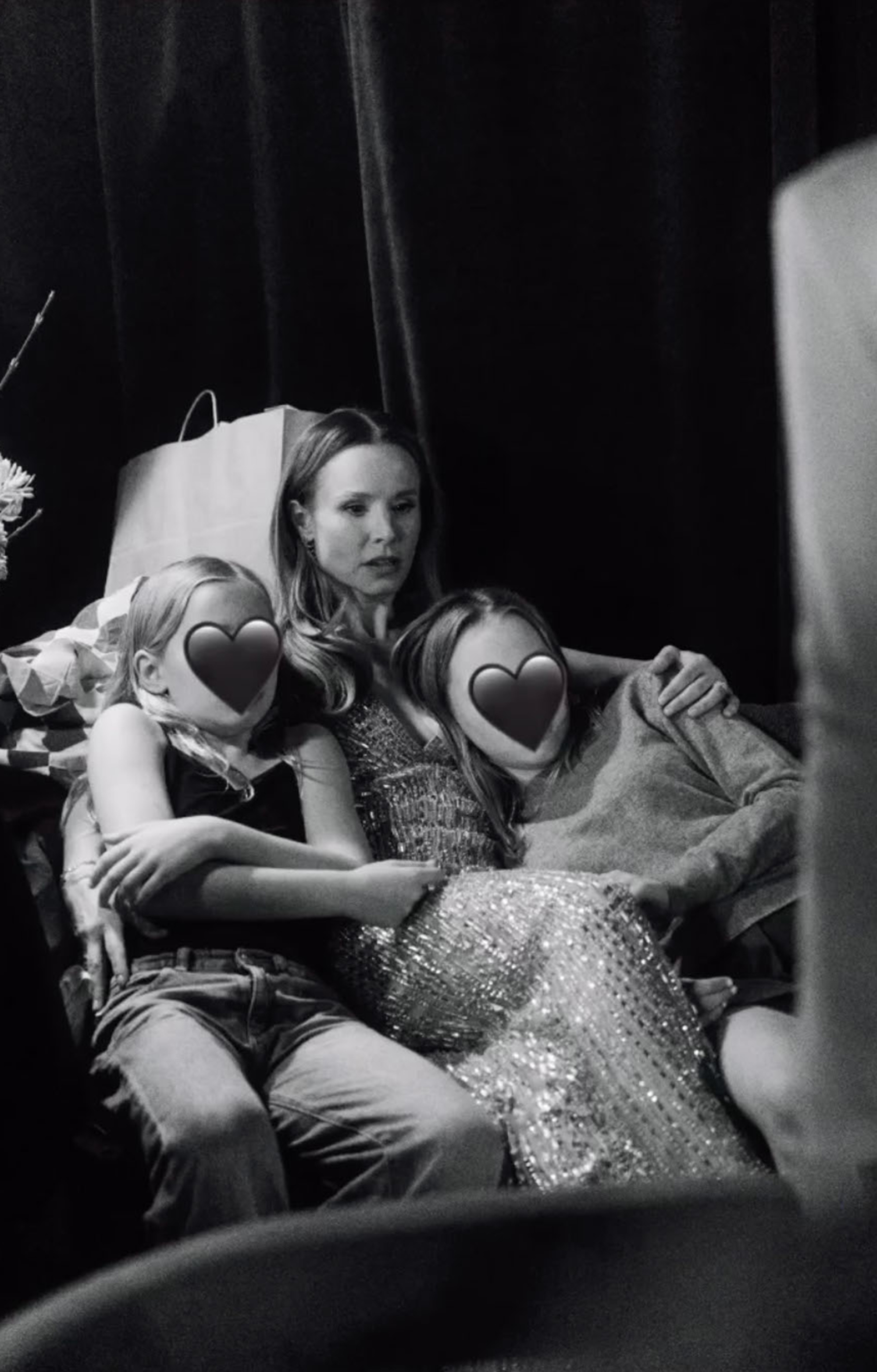 Kristen Bell sitting backstage with her two daughters.