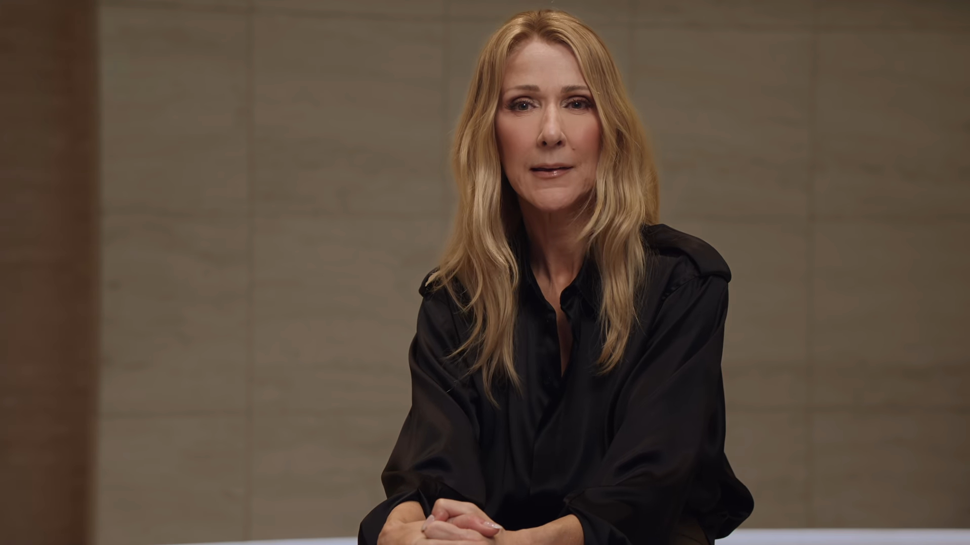 Celine Dion in a black shirt.