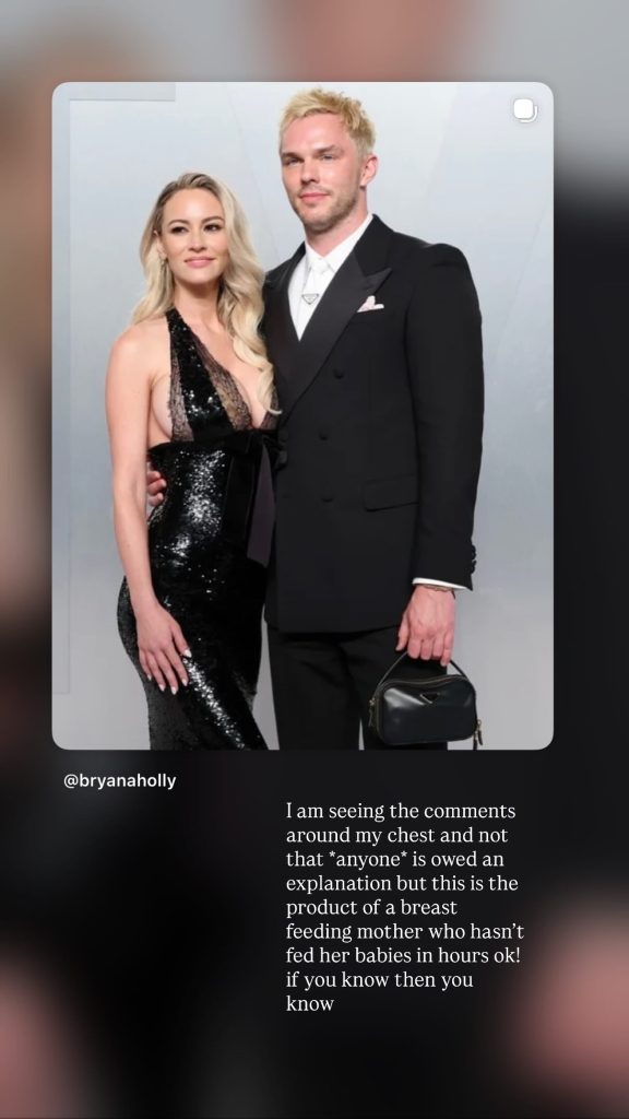 Bryana Holly in a black sequin dress and Nicholas Hoult in a black suit.