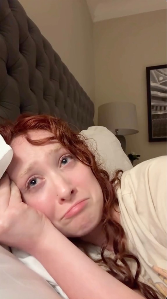 Chappell Roan lying in bed with a sad expression.